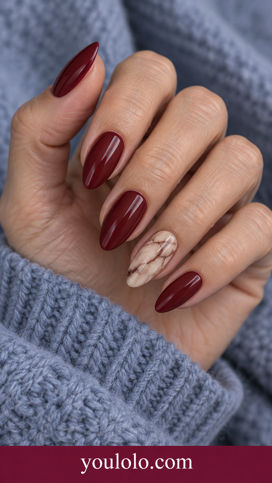 Wine Stone Accent: maroon nails with one full beige marble accent nail on a naturally posed adult hand