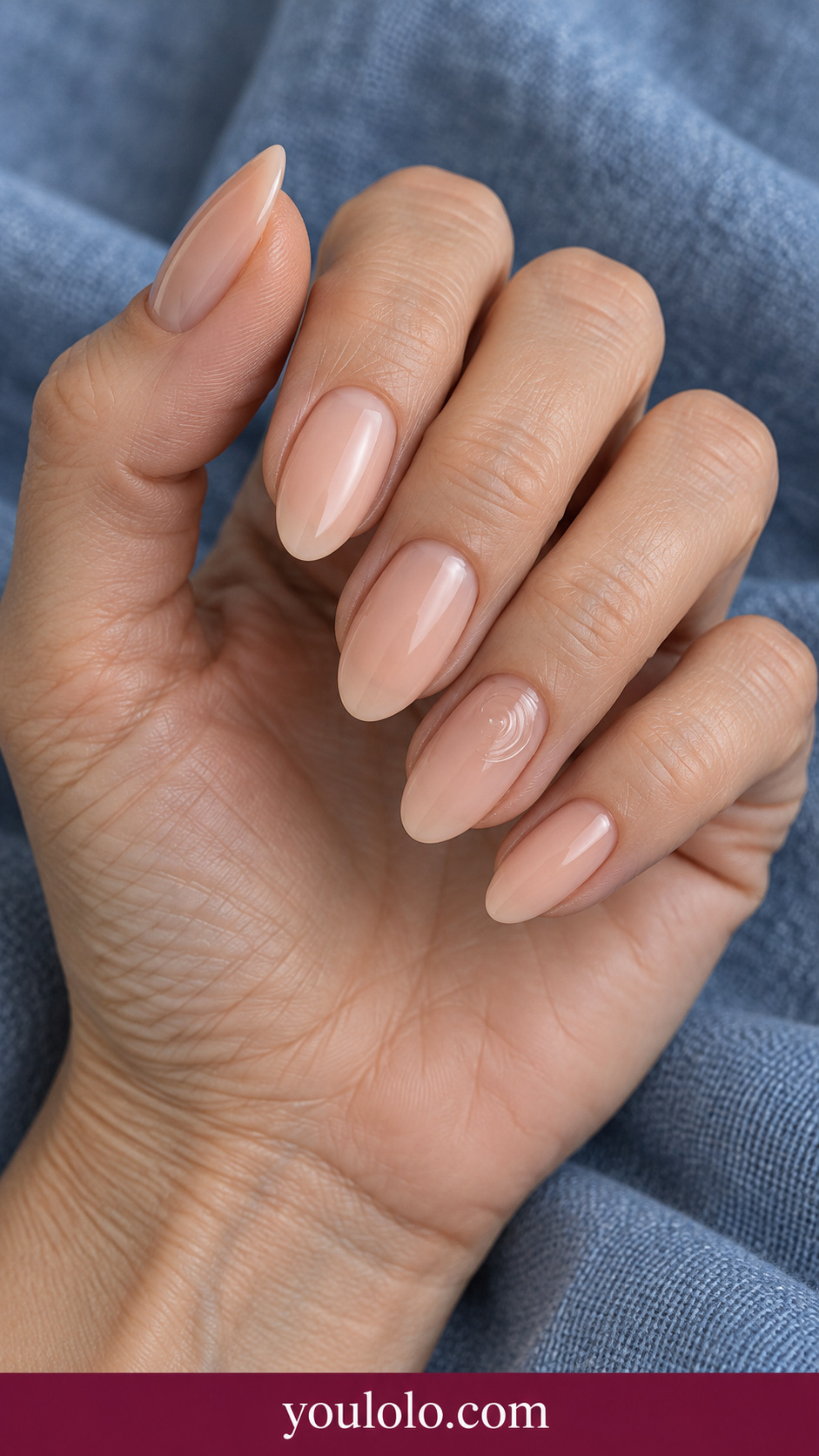 Peach Glass Ripple: medium oval sheer peach nails one accent three tiny clear raised concentric ripple arcs offset toward side on a naturally posed adult hand