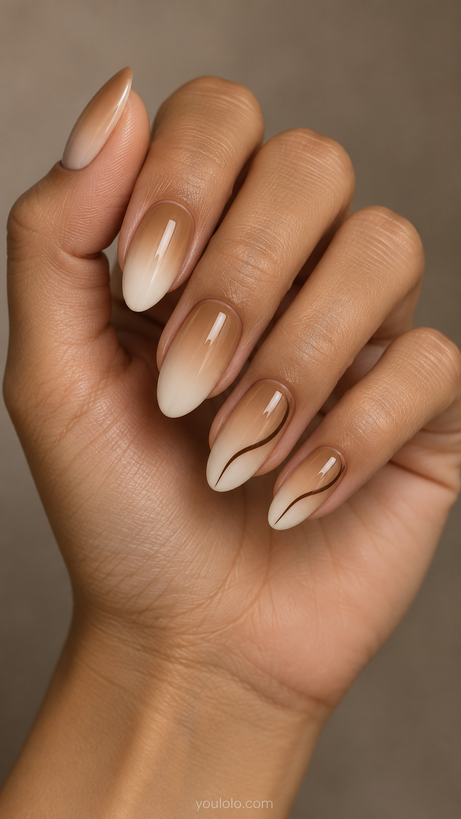 Caramel-to-ivory almond nails with thin brown contour lines