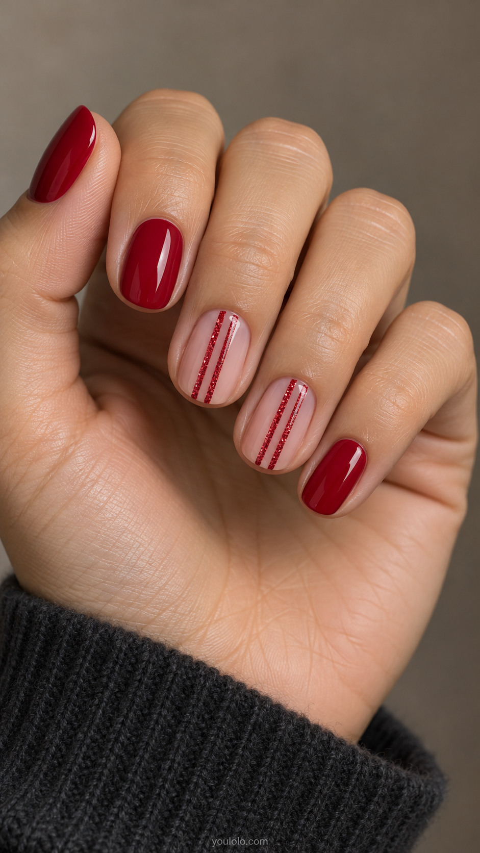 Crimson and nude oval nails with twin red glitter pinstripes