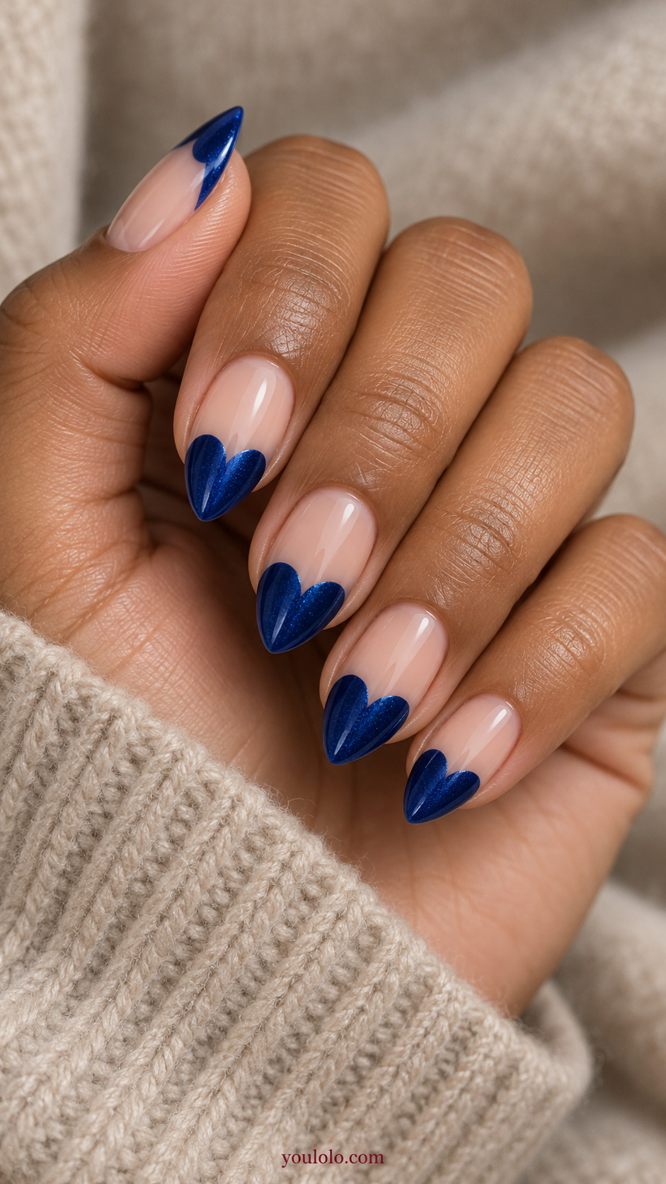 Sapphire Tipped Heart Silhouettes on a softly gathered feminine hand with detailed sapphire blue manicure