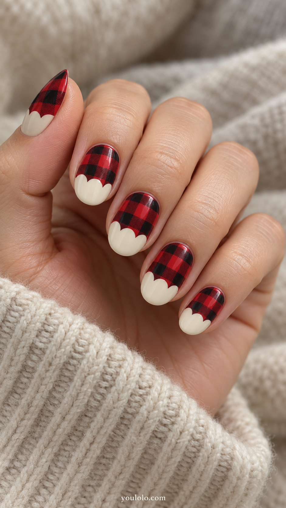 Red-and-black plaid nails with scalloped cream tips