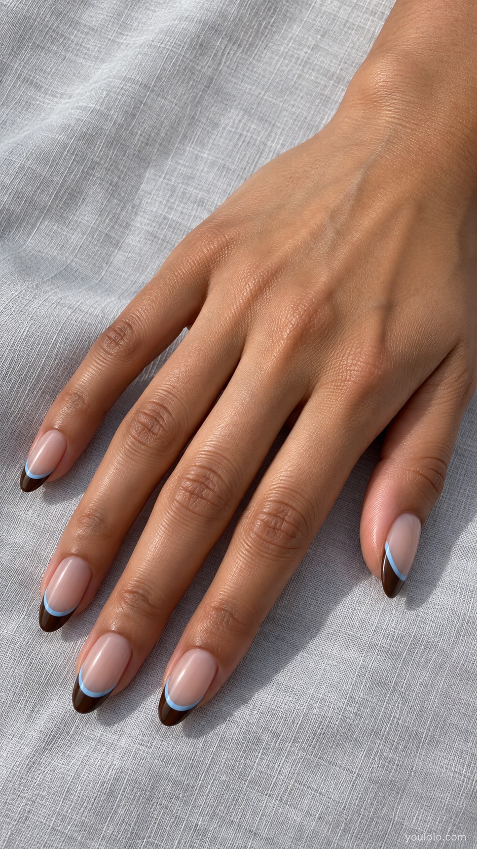Chocolate Sky Double French — medium almond sheer neutral beige base chocolate French tips with separate thin sky blue curve below