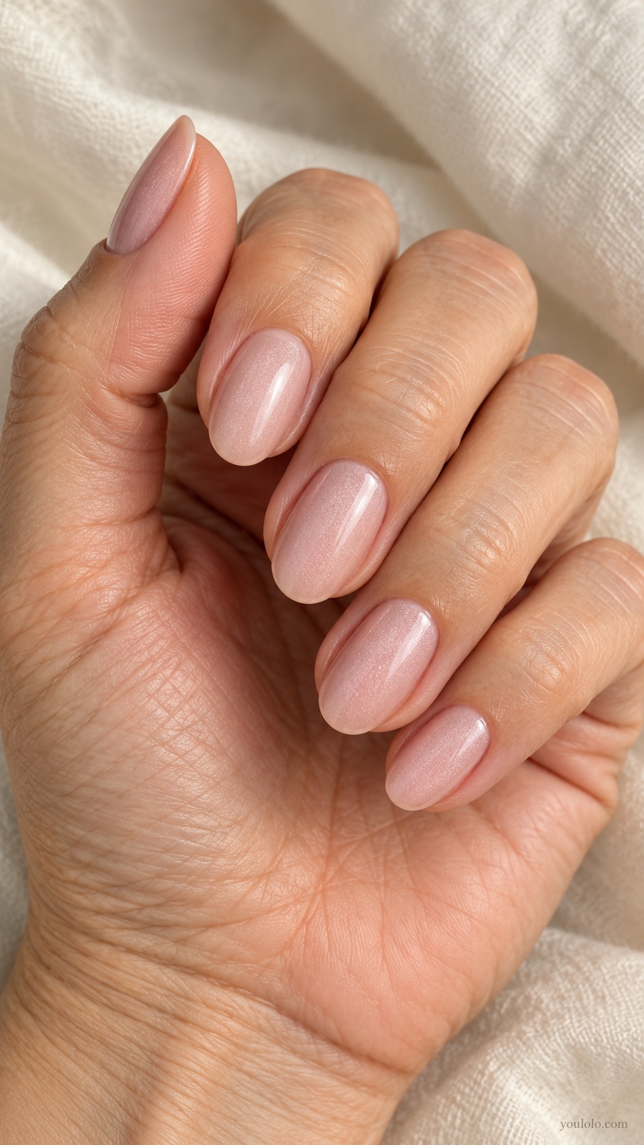 Medium oval nails pale sandy pink delicate pearl sheen no mirror chrome