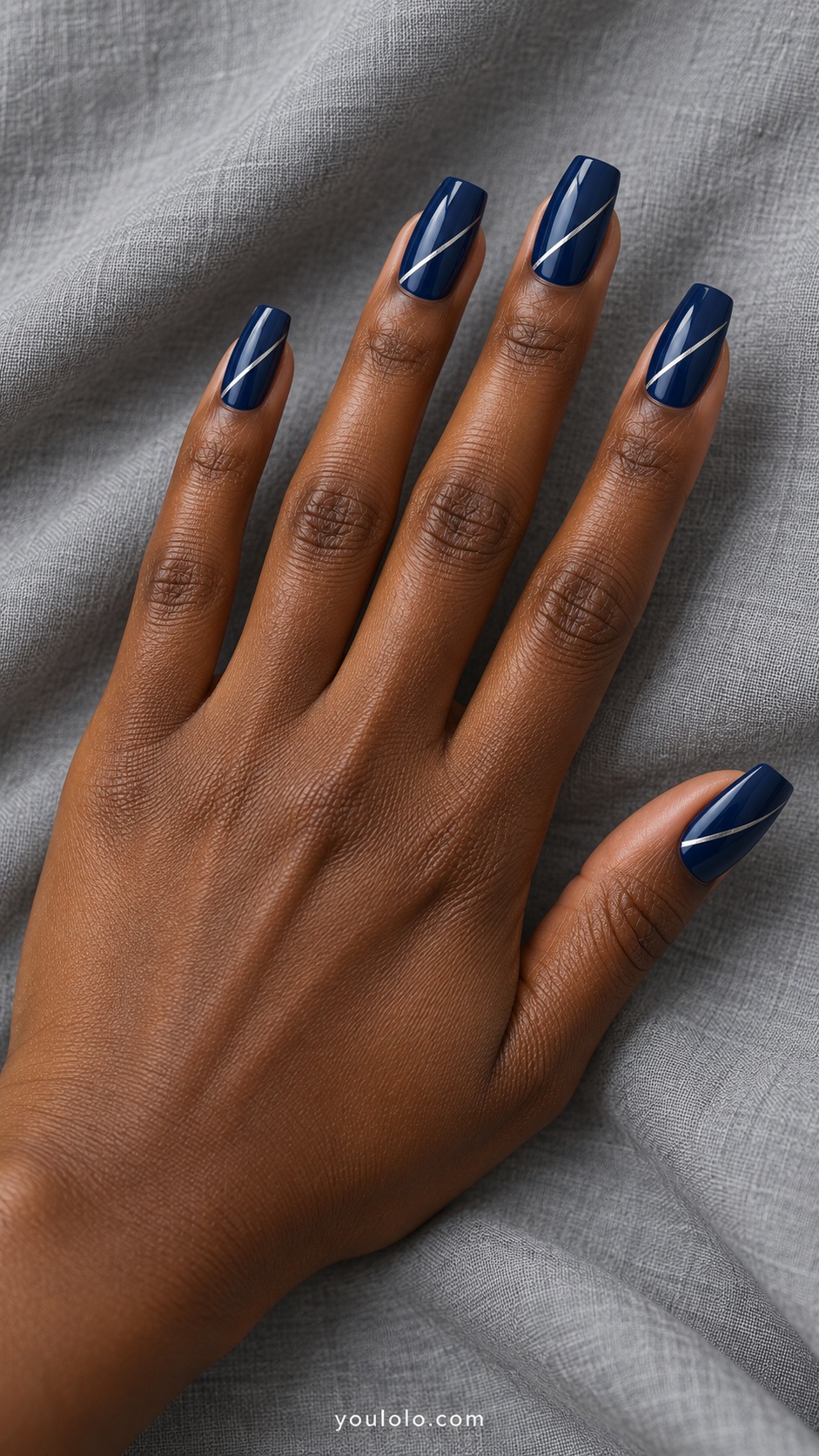Medium tapered square acrylic extensions glossy ink blue with one very thin silver diagonal line each nail
