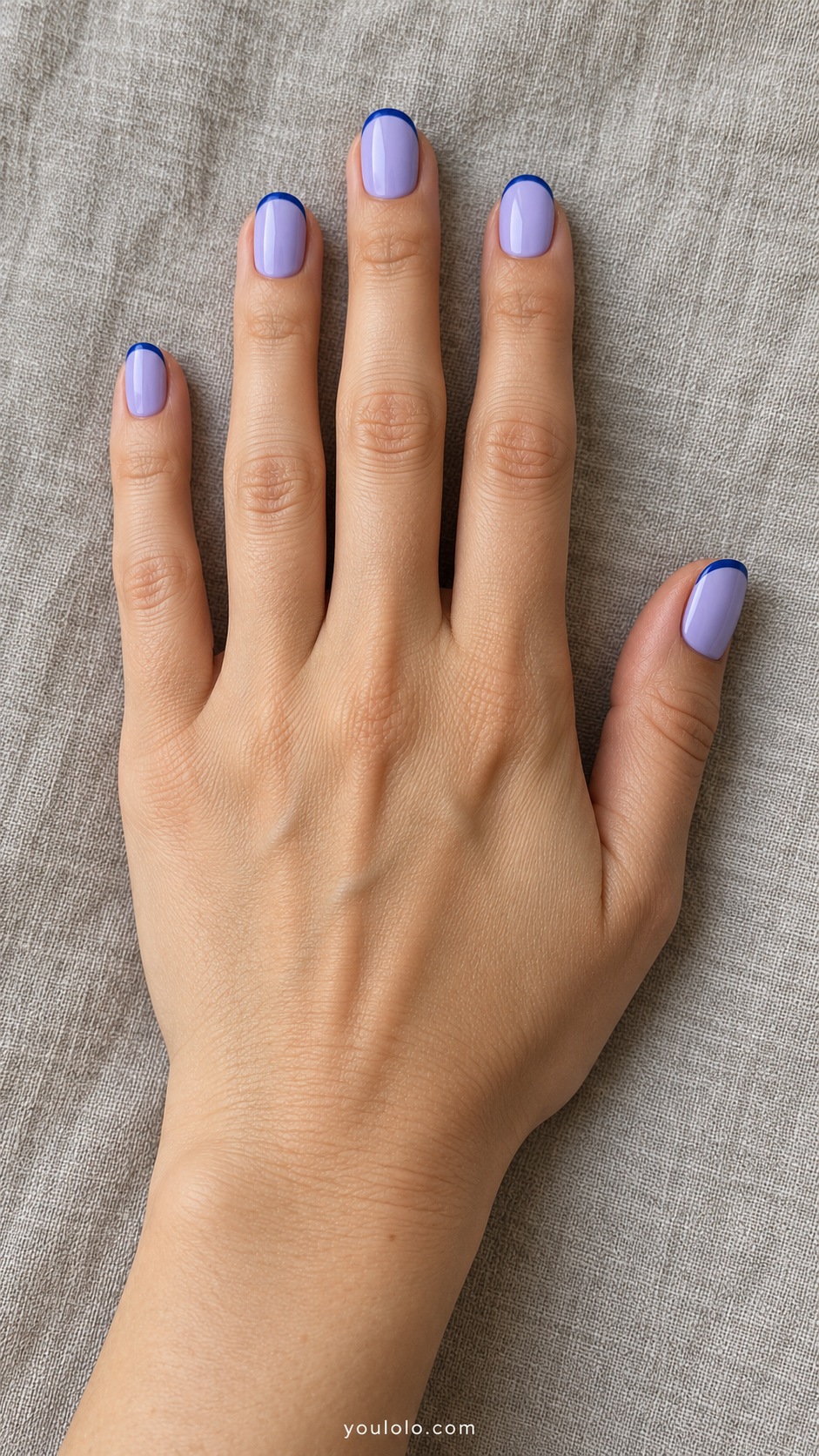 Short oval nails pale blueberry lavender cream with thin deep blue curved outline at tips