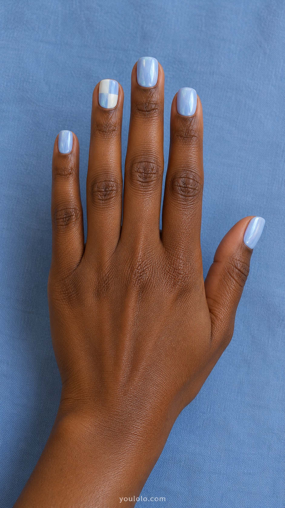 Short square pale blue pearl nails, one accent nail four large alternating ivory and pale blue glazed checker squares