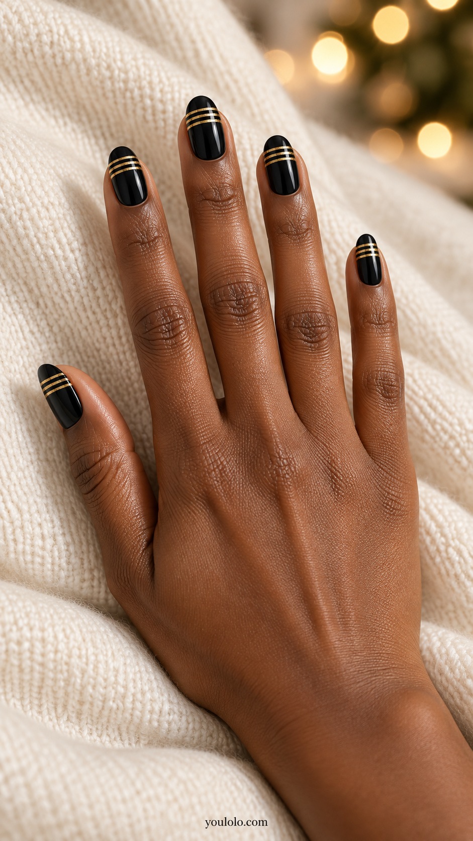 Medium oval glossy black nails three fine gold transverse bands evenly spaced near free edge