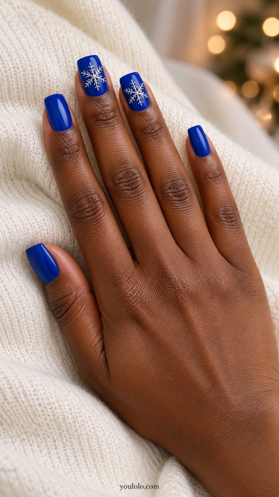 Medium square cobalt blue nails one silver outlined six branched snowflake on each middle and ring nail