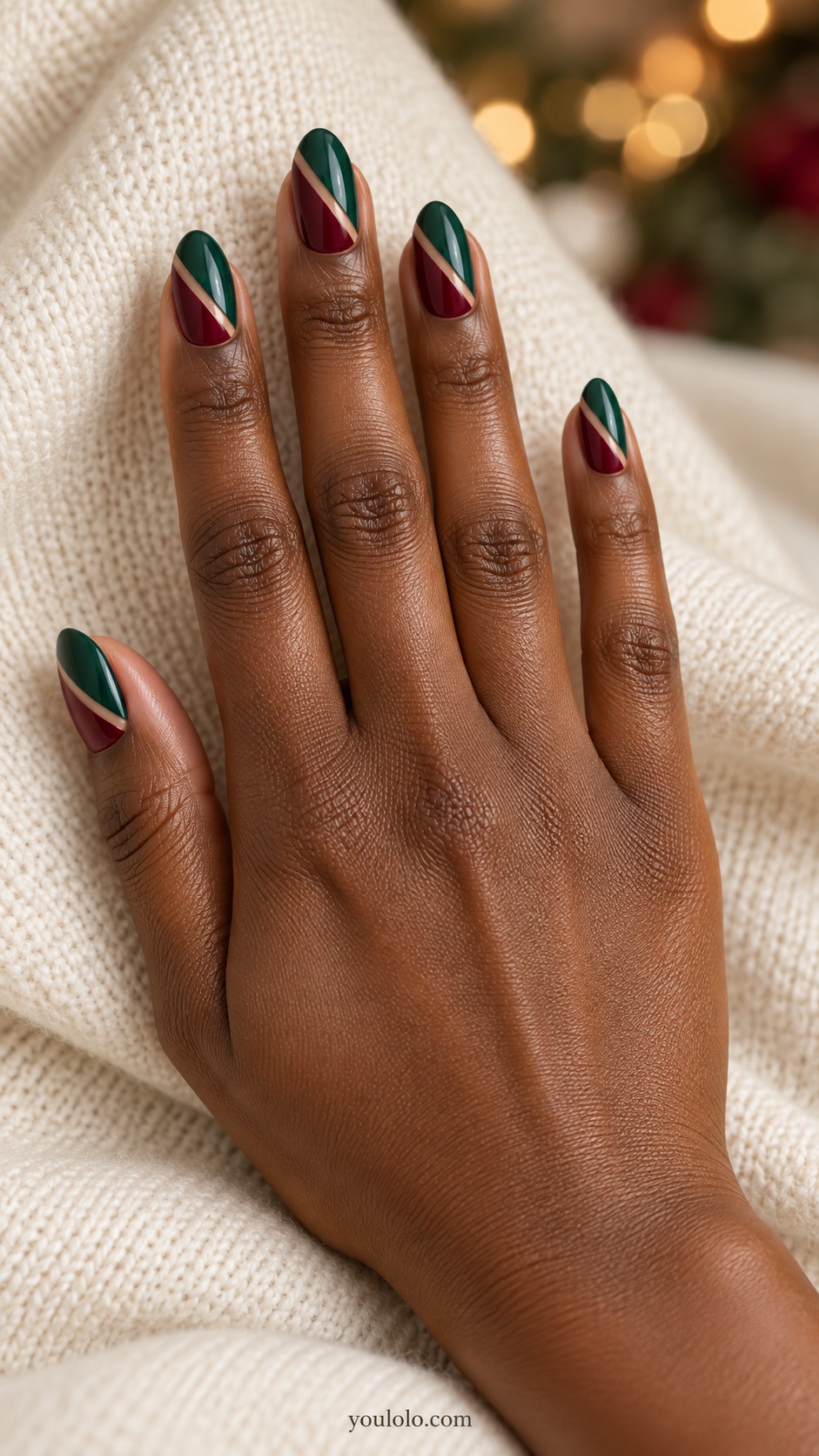 Medium almond nails geometric diagonal emerald and burgundy halves separated by fine nude seam