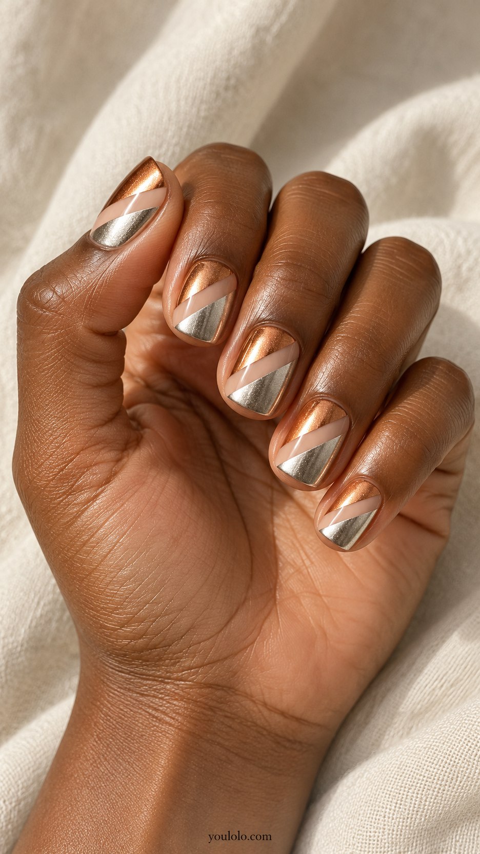 Copper-Silver Color Blocking: short square nails, diagonal copper and silver metallic panels separated by nude negative-space stripe