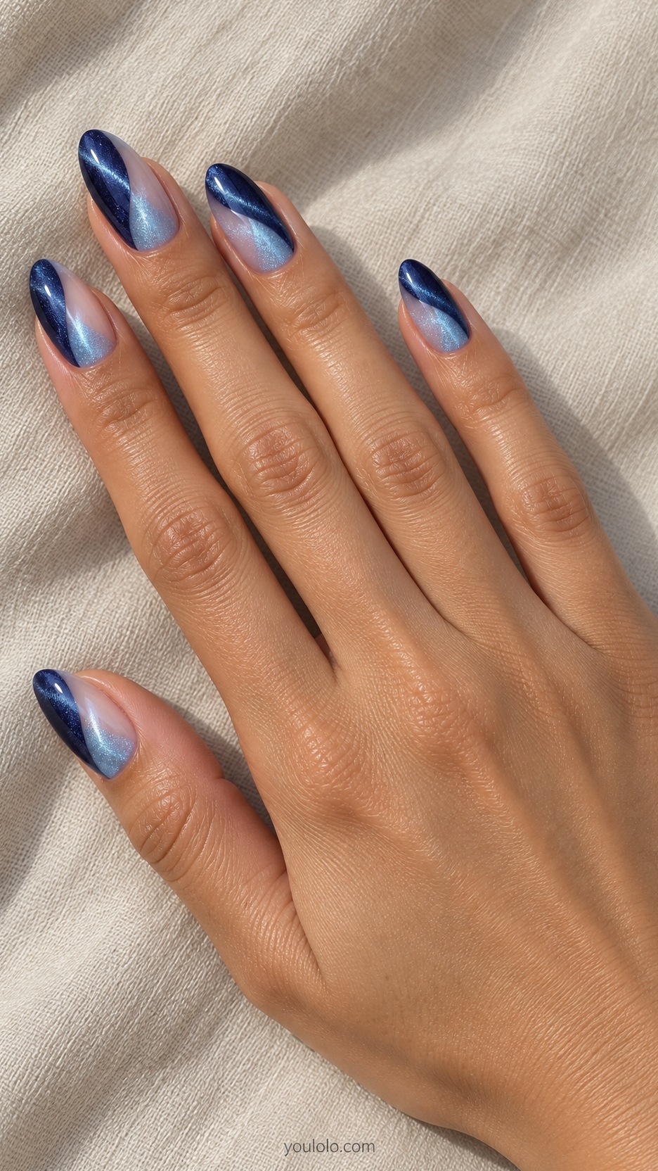 French Cat Eye Nails: medium almond nude beds tips split navy magnetic one side and icy blue magnetic other side