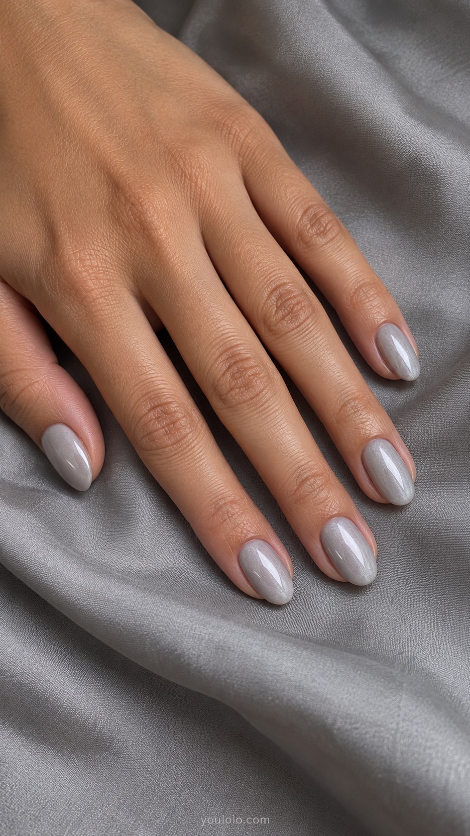Short Almond Nail Designs: Dove Gray Pearl manicure on a naturally posed hand