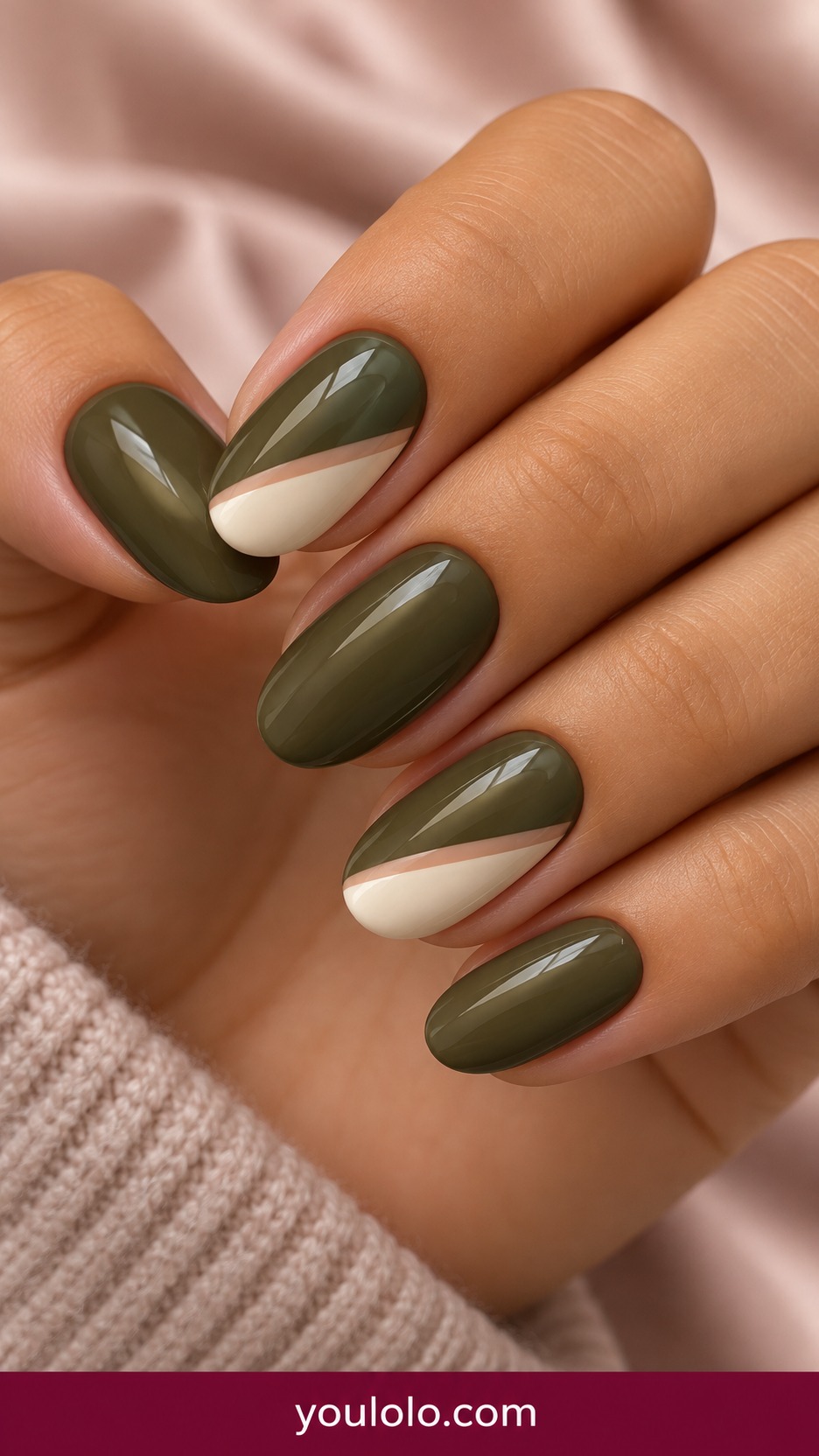 Medium oval olive nails with cream diagonal corner on two accents and thin nude separator on a naturally curled young adult hand