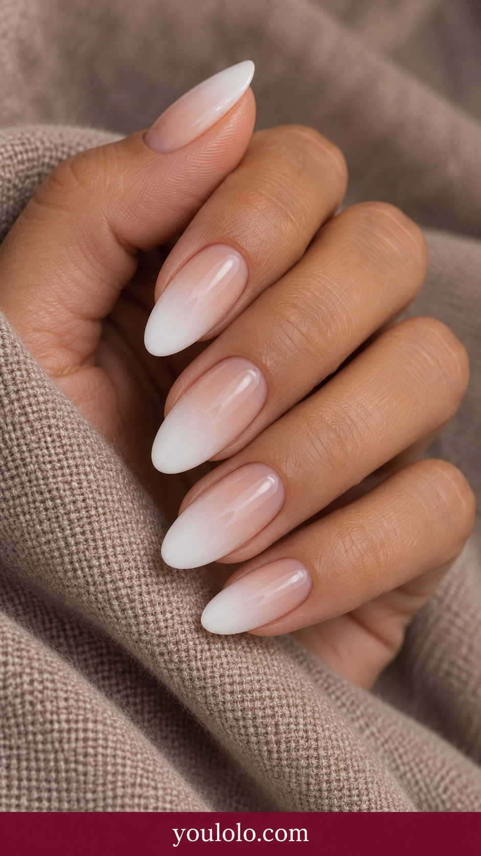 medium almond beige nude cuticle smoothly fading to opaque soft white tip, glossy no art on a naturally relaxed adult hand