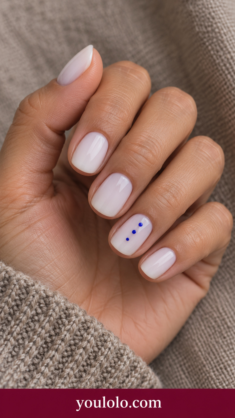 Cobalt Dot Ladder: short squoval milky white nails three tiny cobalt dots vertically spaced on ring nail on a naturally posed adult hand
