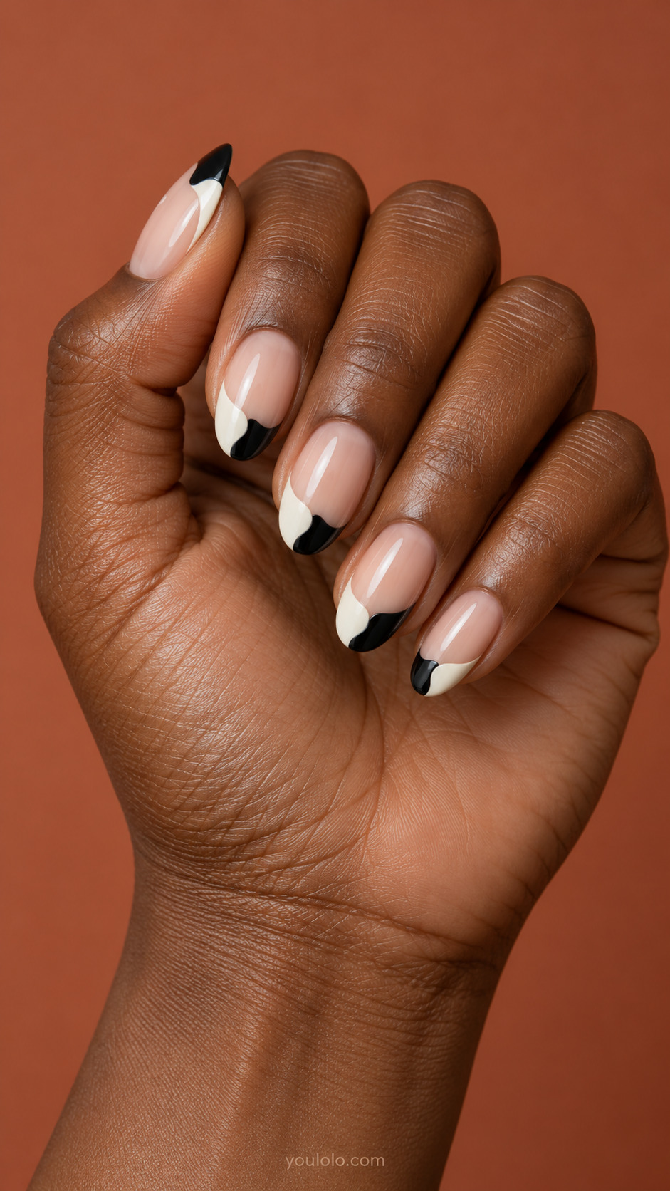 Black and White Puzzle Tips on almond nails with a nude base