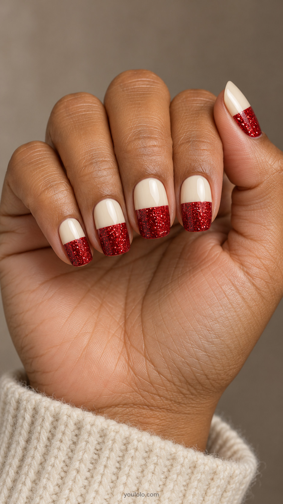 Squoval nails divided into cream bases and straight red glitter tips