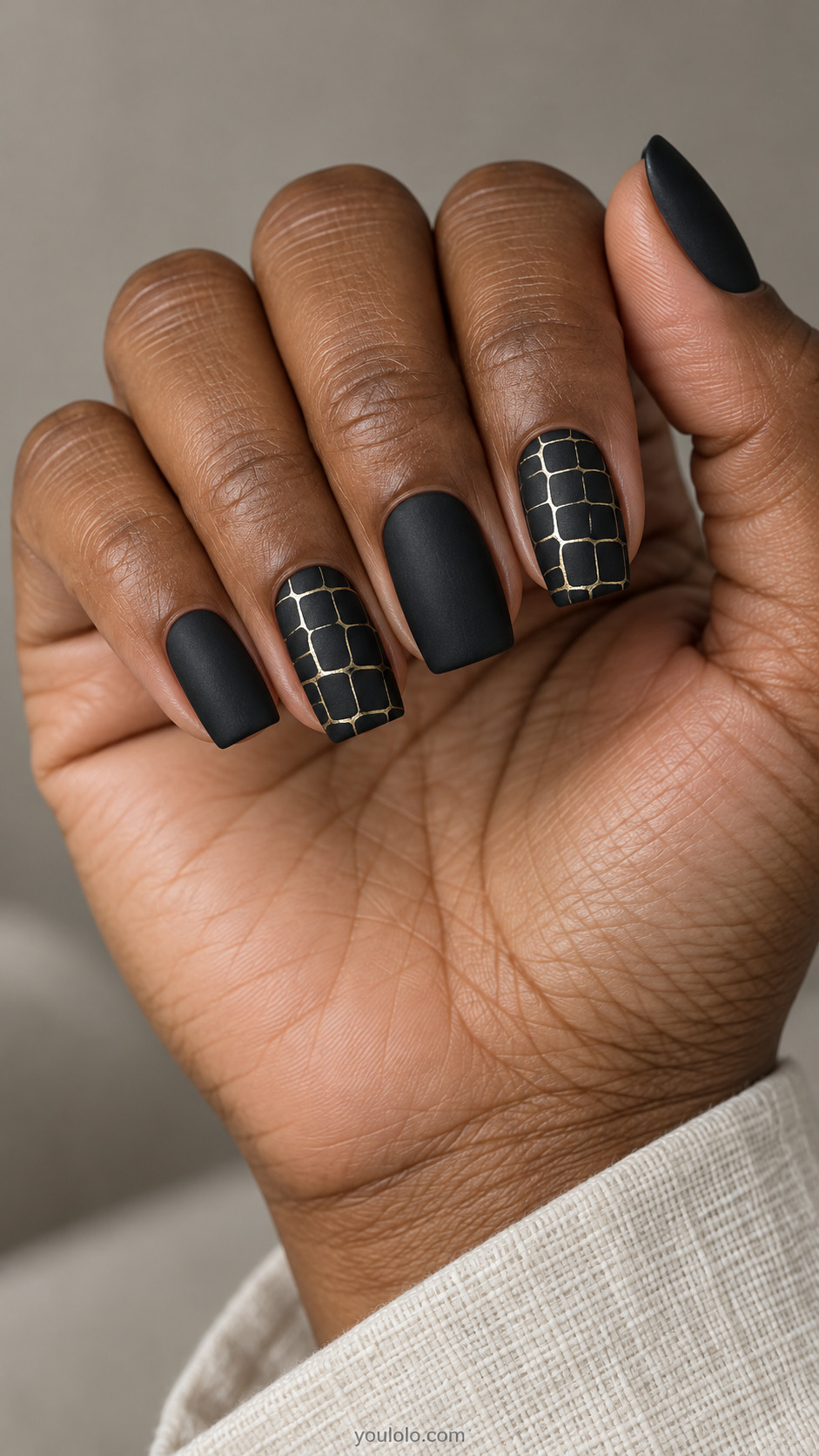 Matte-black square nails with fine gold crocodile-scale outlines