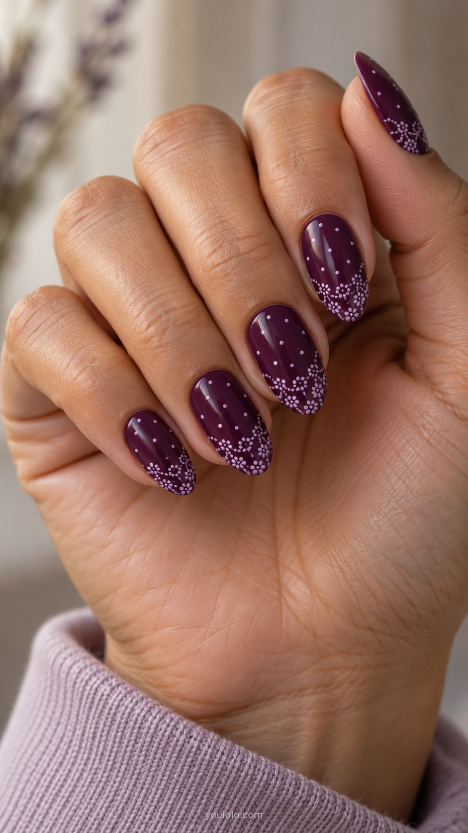 Plum almond nails with lilac dotted lace loops along the tips.
