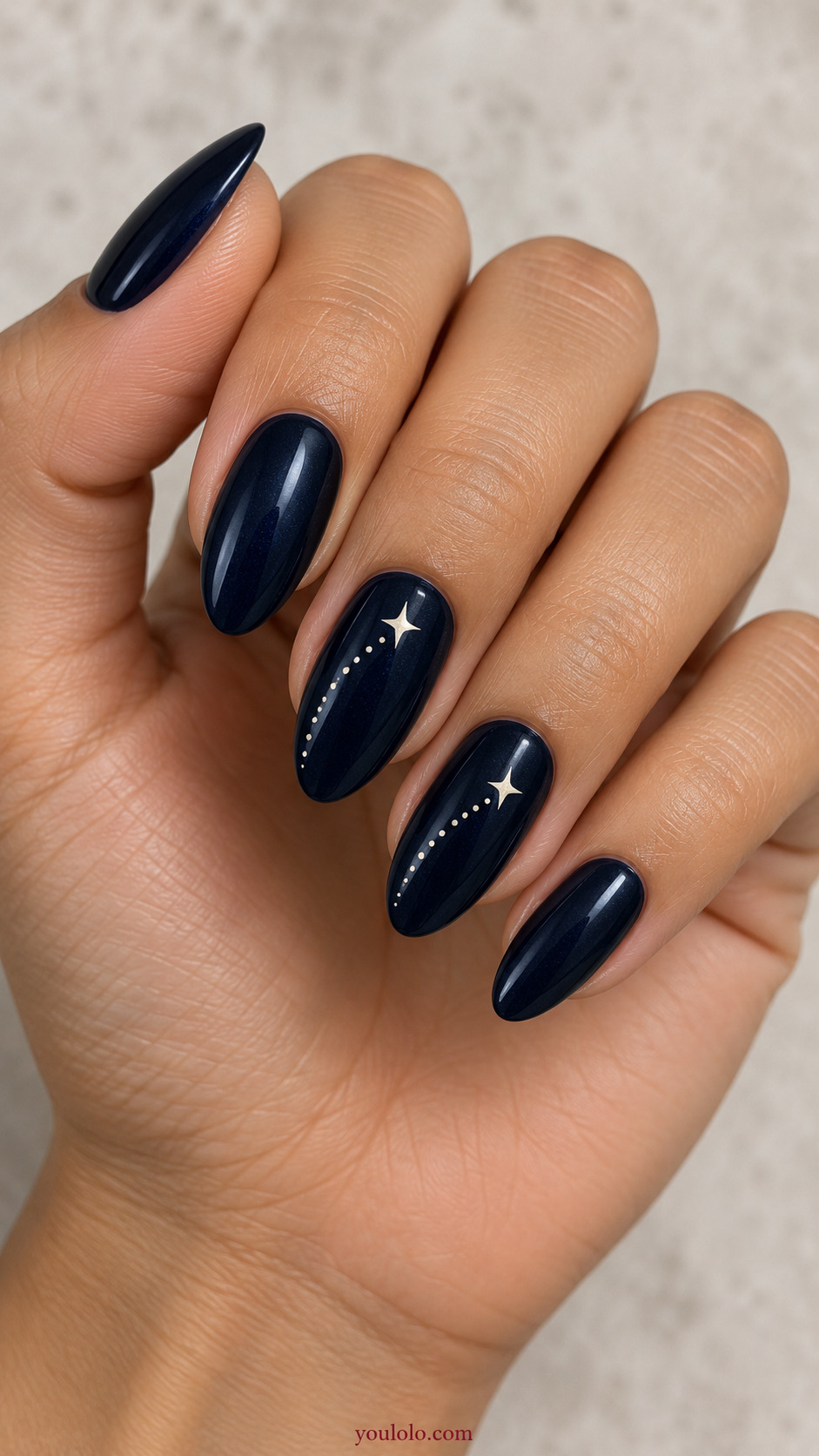 Shooting Star Across Two Accent Nails on a naturally posed hand, showing dark blue polish and detailed nail art