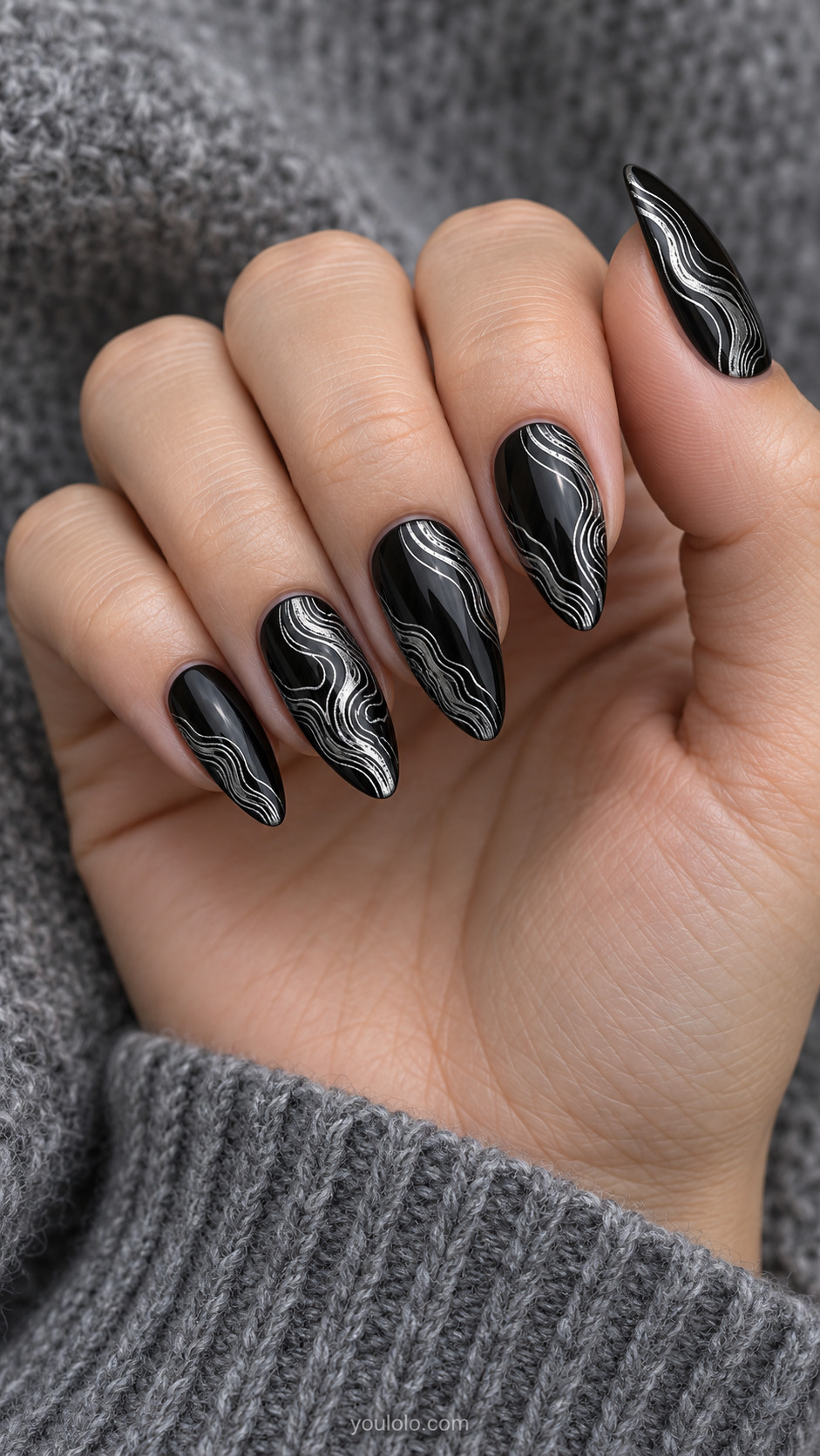 Long almond black nails tightly spaced reflective silver topographic contour lines concentrated along one side, winding smooth organic contour mapping