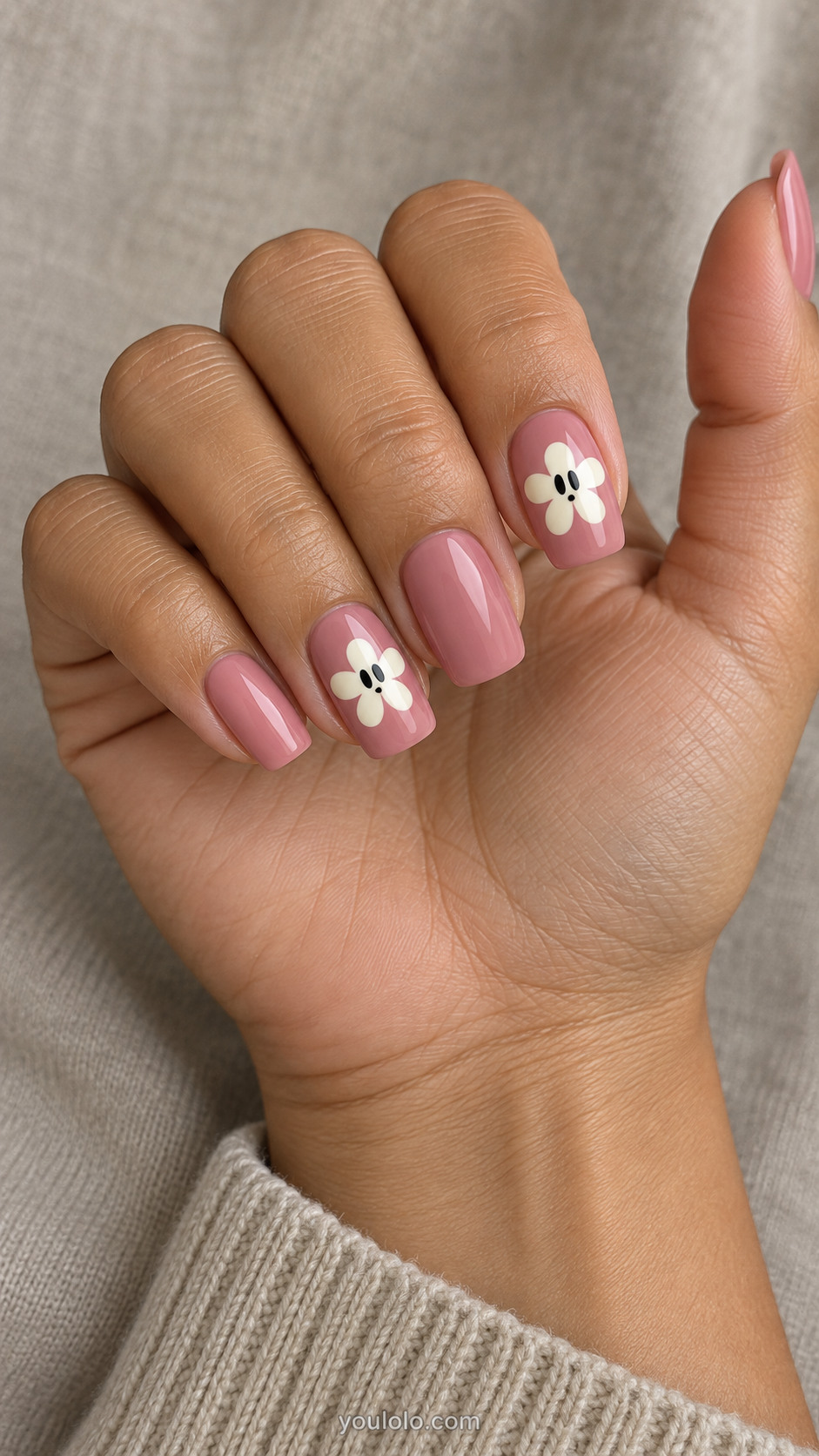 Rose pink nails with cream daisies and dark ghost-face centers