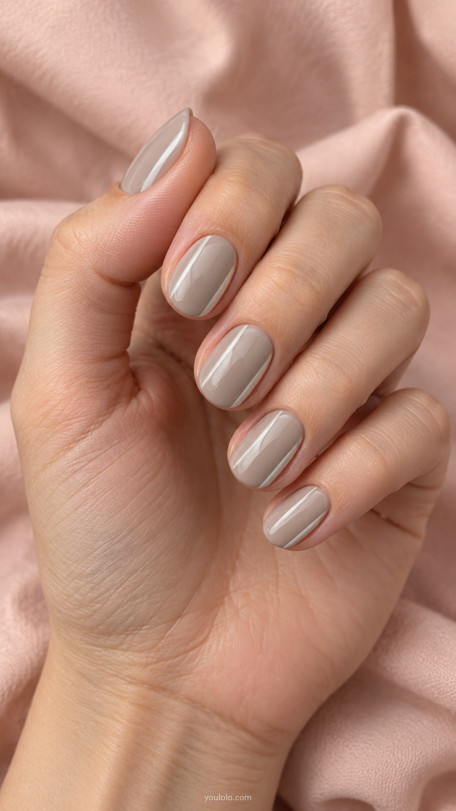 Short oval nails light desaturated cool fawn beige with thin off white side stripe on each nail