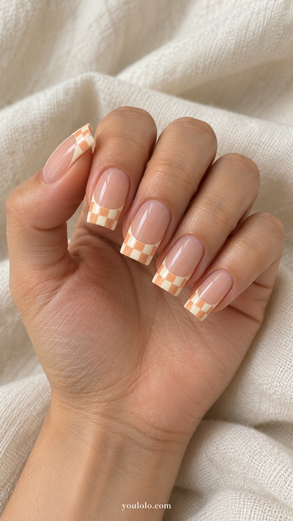 Medium square acrylic extensions nude beige base apricot and ivory checkerboard French tips