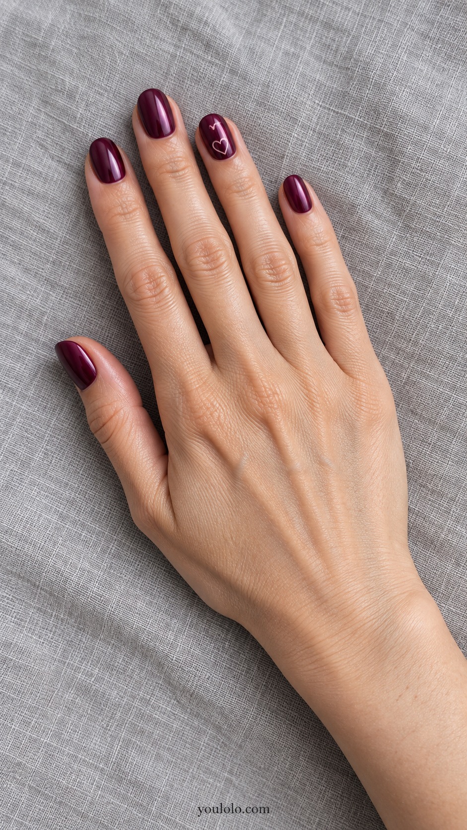 Short oval berry burgundy pearl nails one accent nail tiny pale pink outlined heart near base