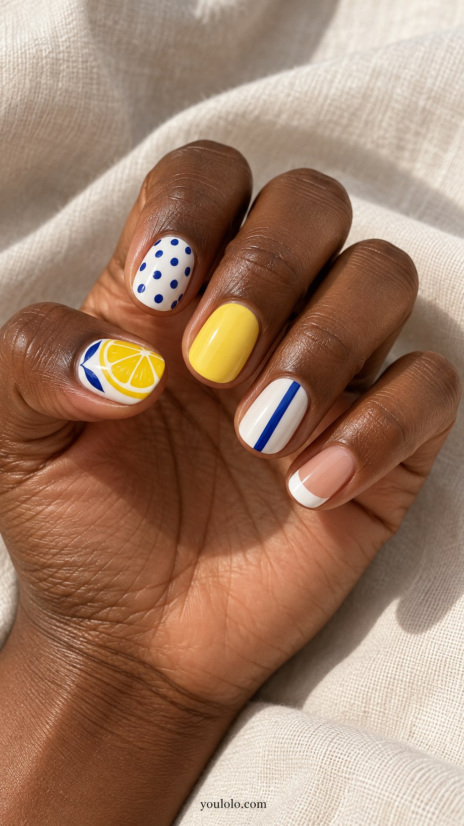 Lemon-and-Blue Weekend: short rounded lemon yellow cobalt white nails: lemon slice, blue polka dots, yellow solid, thin blue stripe, white tip