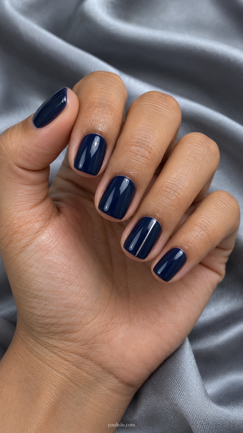 Short Press-On Nails: Navy and Silver Line manicure on a naturally posed hand