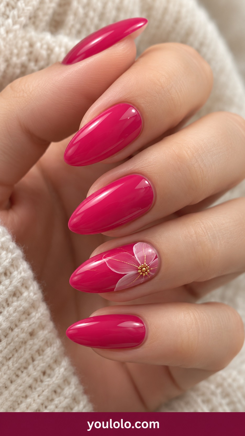 Medium oval fuchsia pink nails one accent fine pale pink flower outline with tiny gold center on a naturally curled young adult hand