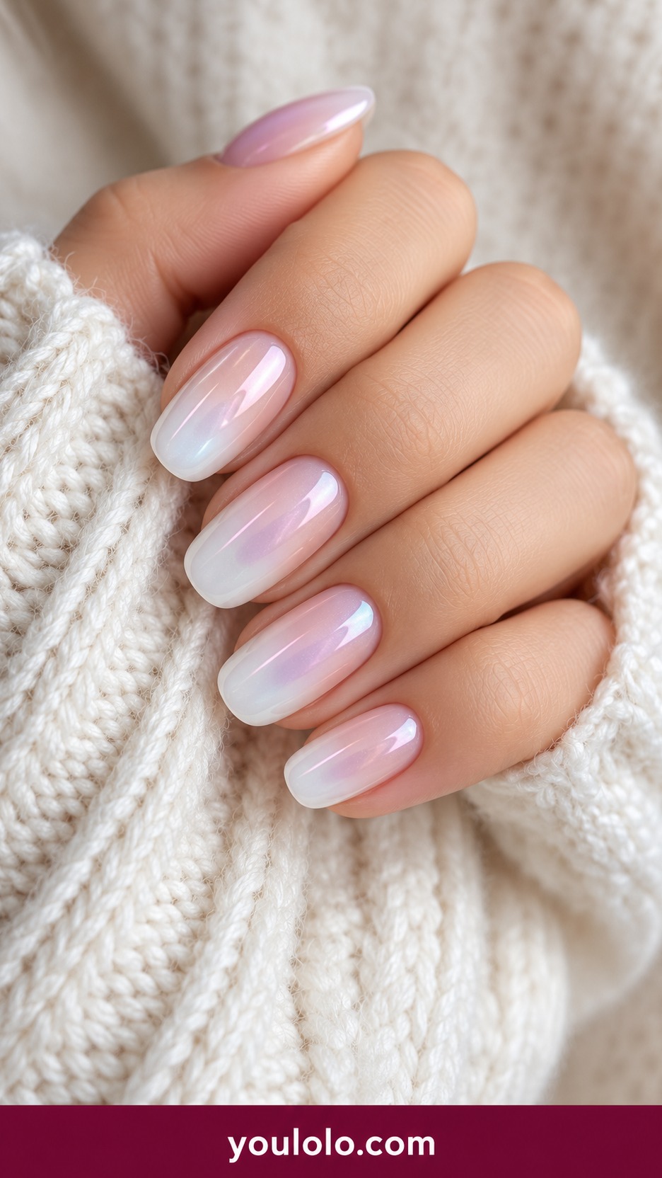 Medium soft square opalescent milky white nails with subtle pink blue shifting pearly sheen no glitter chunks on a naturally curled young adult hand