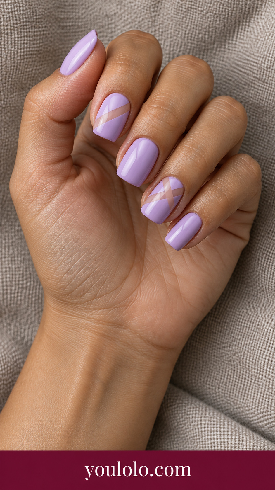 medium squoval lilac press-on nails single clean diagonal sheer nude stripe on index and ring only, others plain lilac on a naturally posed adult female hand