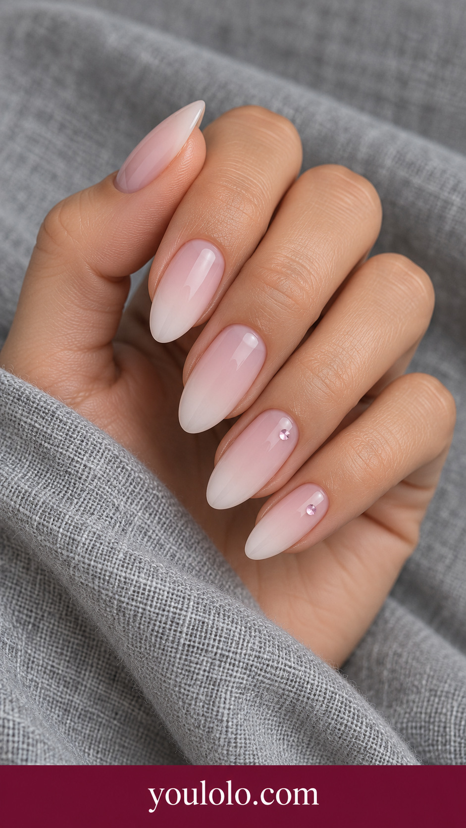 Pink Milk Staggered Gems: medium almond milky pink nails two very tiny pale pink inset crystal dots at different heights on two accents on a naturally posed adult hand
