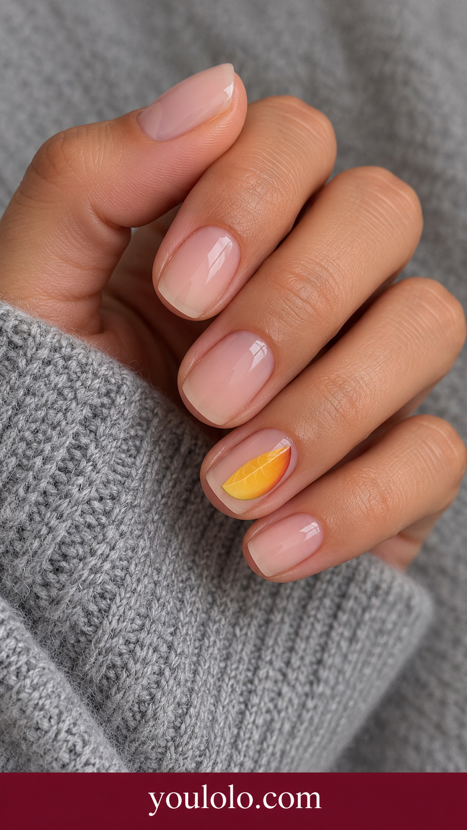 Tiny Mango Slice: short squoval sheer nude nails one accent small flat painted golden orange mango slice with very fine lighter curves on a naturally posed adult hand