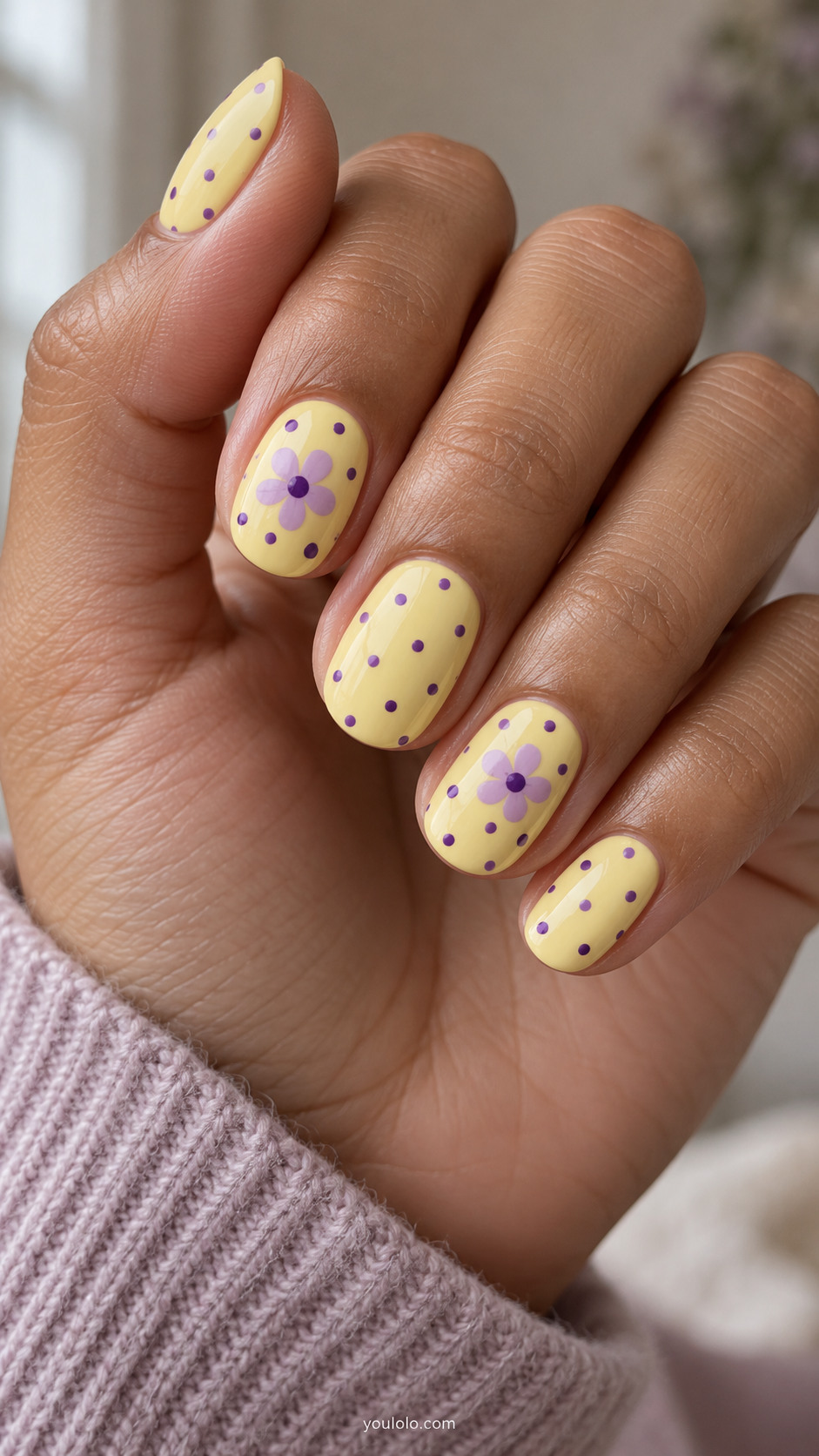 Butter-yellow oval nails with grape dots and lavender flowers.