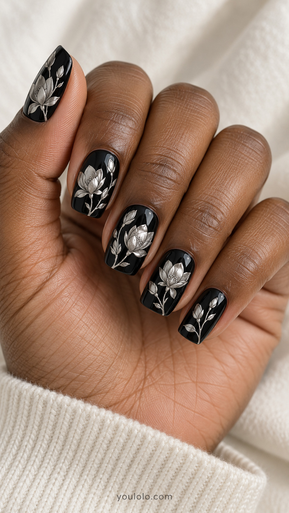 Glossy black squoval nails with shaded silver magnolia flowers, buds and delicate stems
