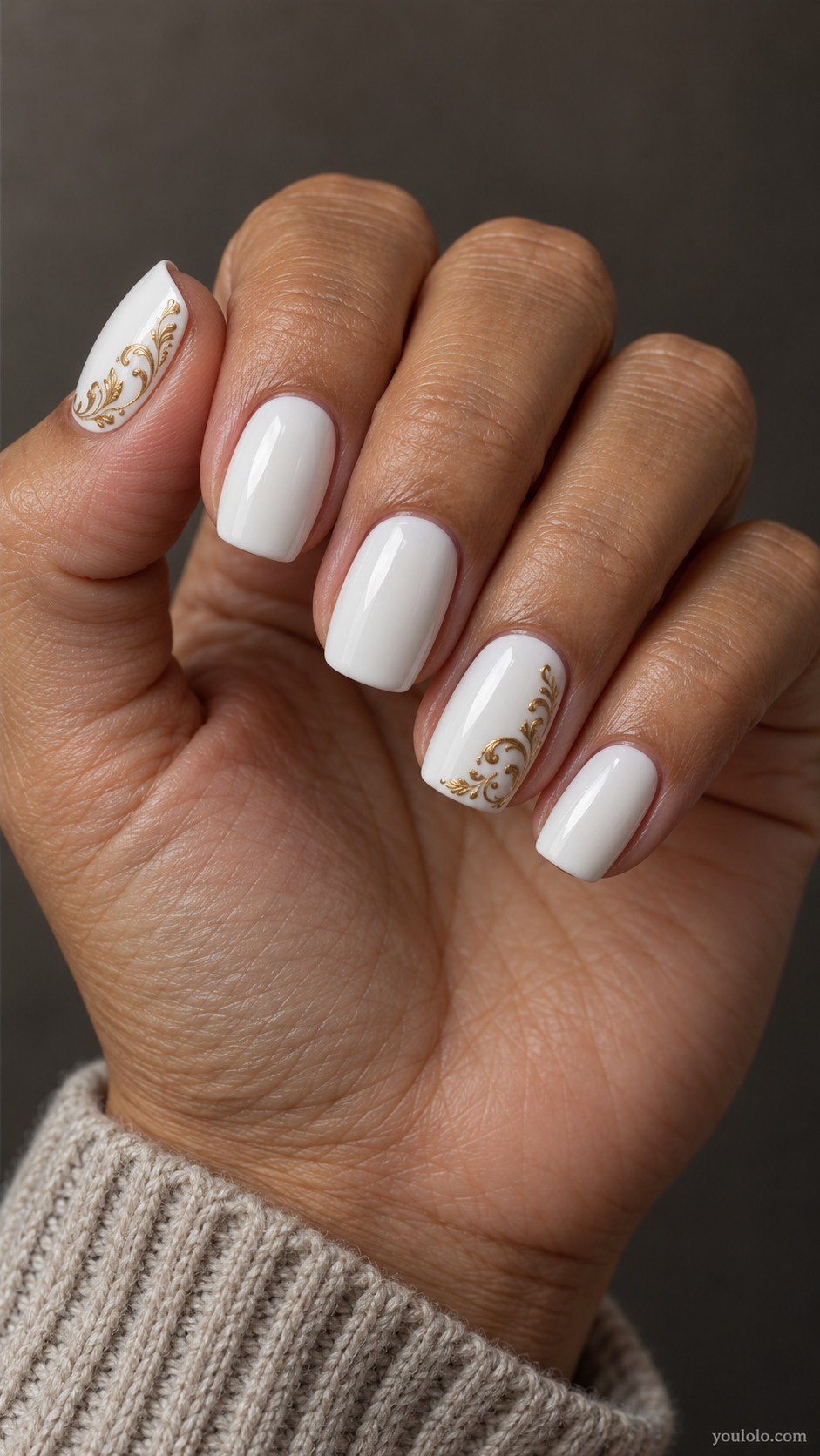 Medium squoval white nails with fine antique-gold scrolls in the corners of two nails