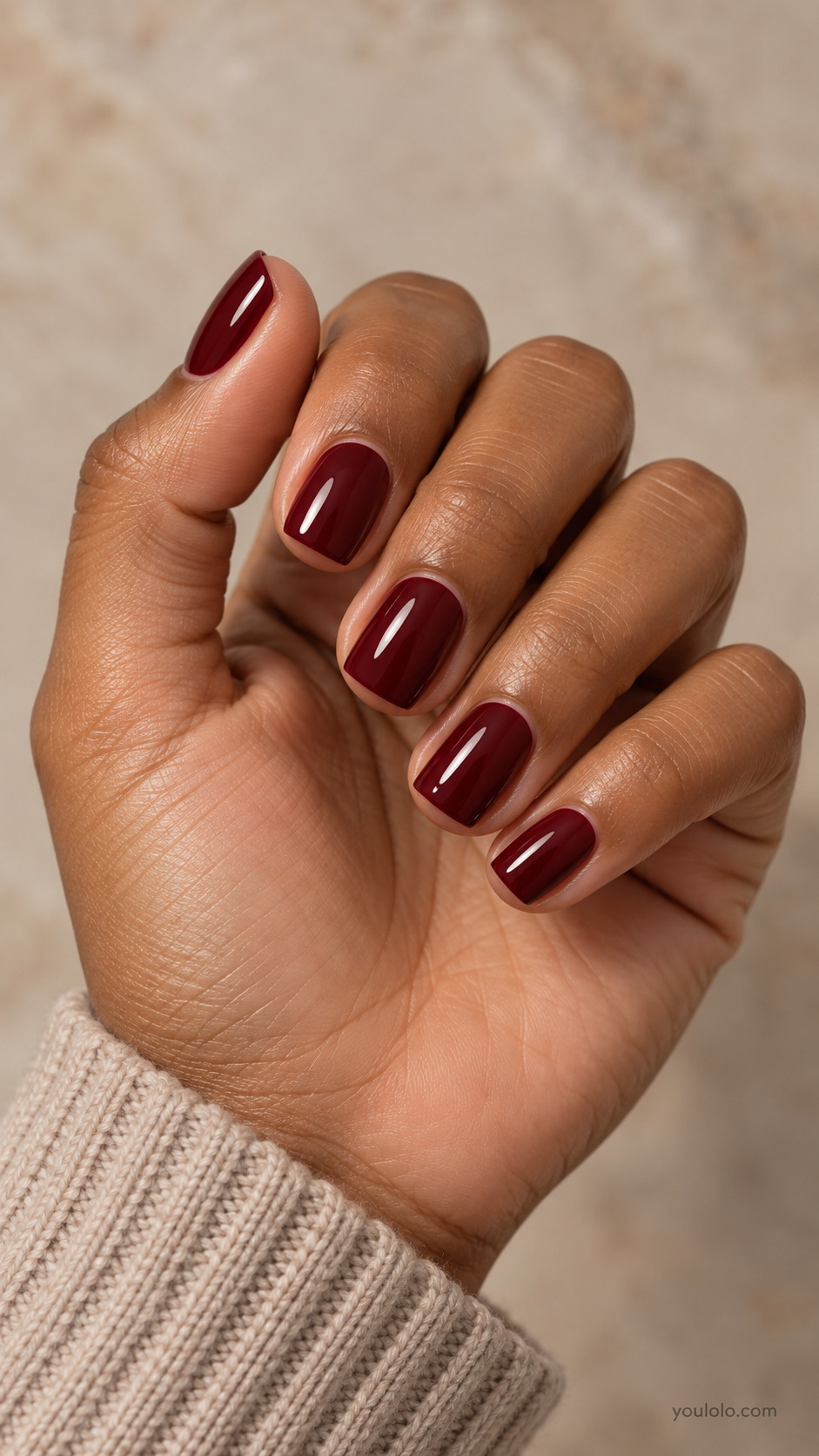 Short soft square nails painted glossy deep oxblood red.