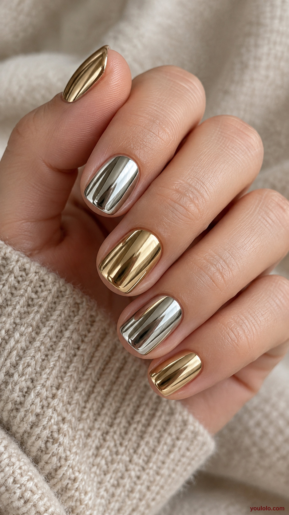 Platinum and Gold Alternating Nails on a naturally gathered feminine hand showing the nail finish