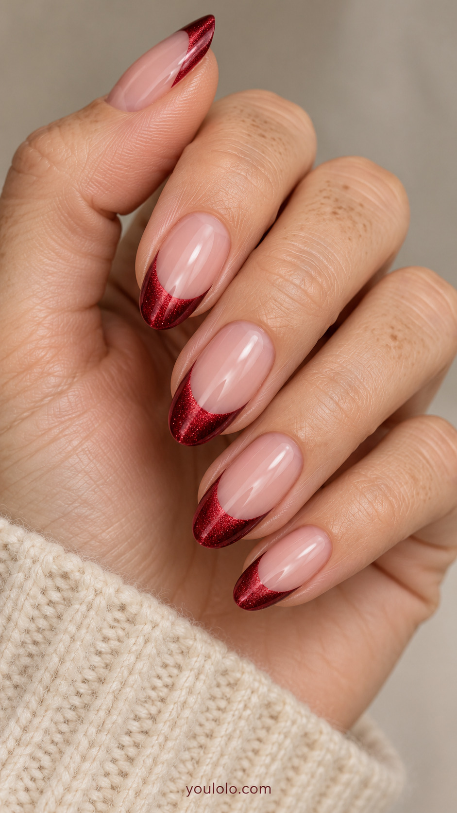 medium almond sheer blush nails, ruby magnetic velvet sheen restricted to French tips on a naturally gathered hand
