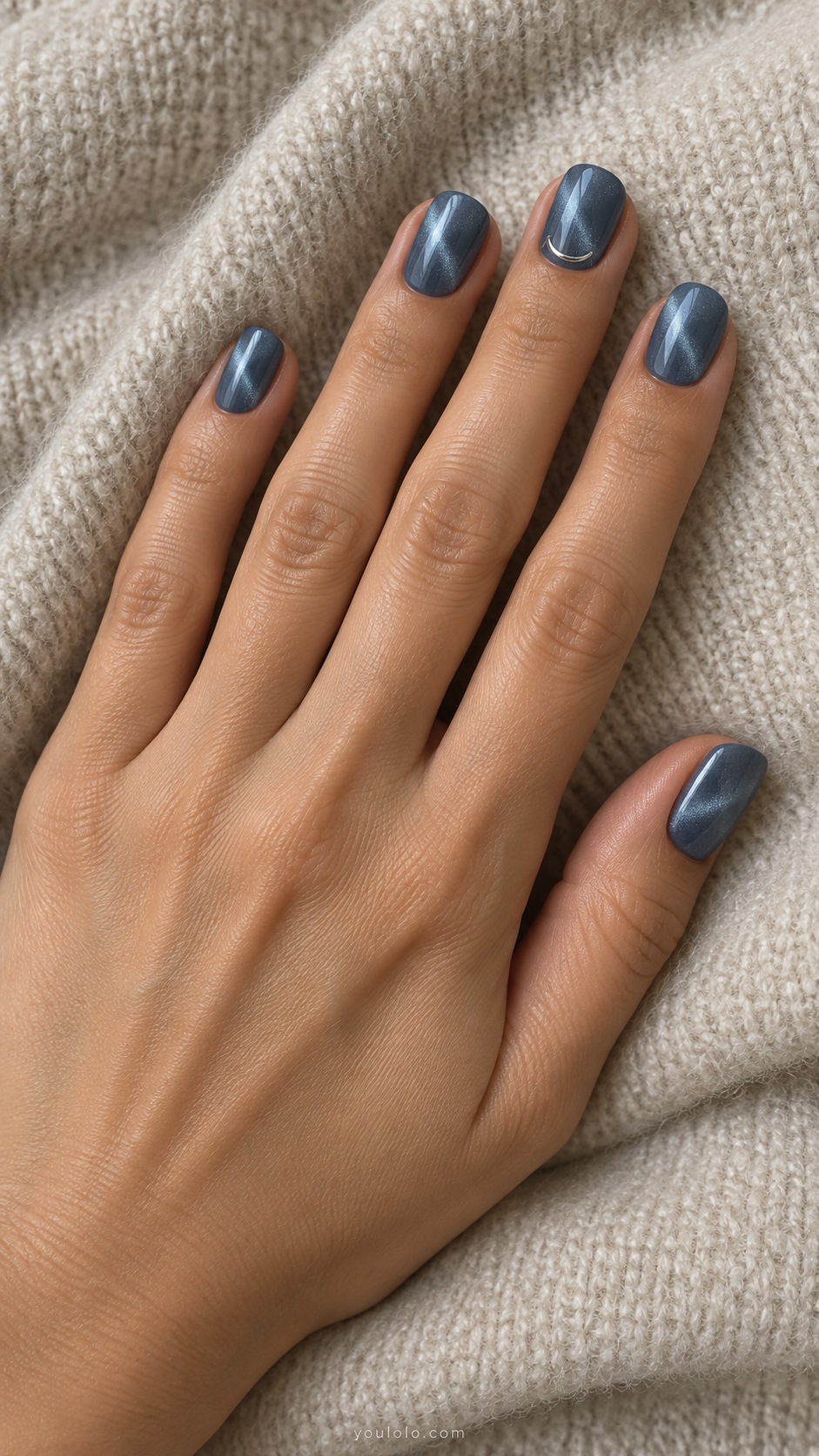 Denim Blue with a Silver Crescent cat eye nails — Short squoval muted denim blue magnetic nails with tiny silver crescent detail near base of middle nail only.