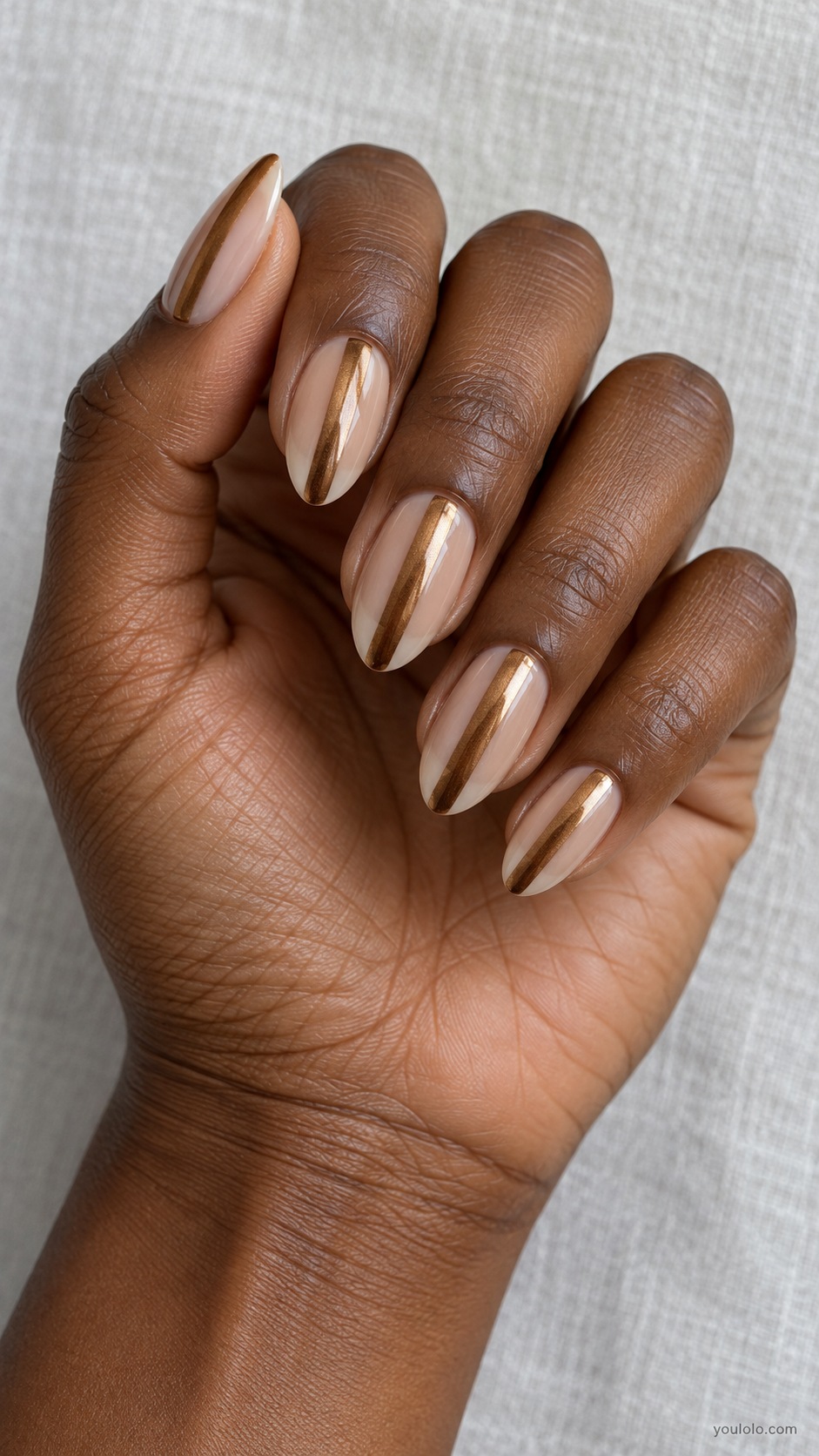 Bronze Negative Space Stripe — medium almond sheer beige nails one wide vertical bronze chrome stripe centered on each nail