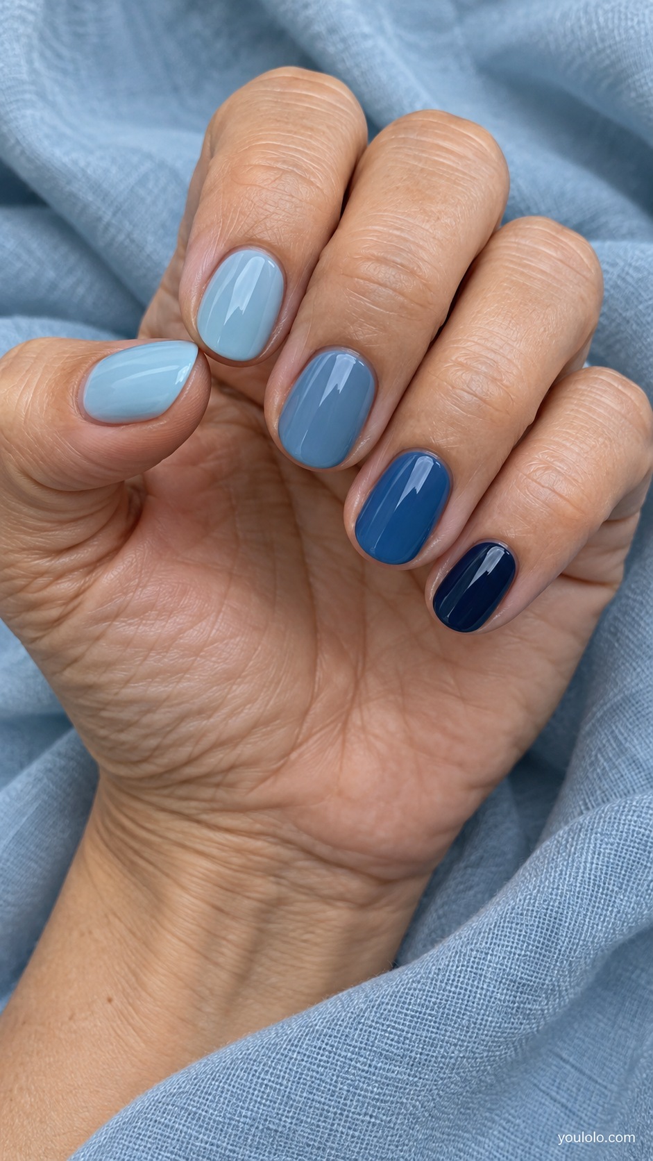 Short oval nails five solid cream shades progressing clear medium sea blue to midnight navy