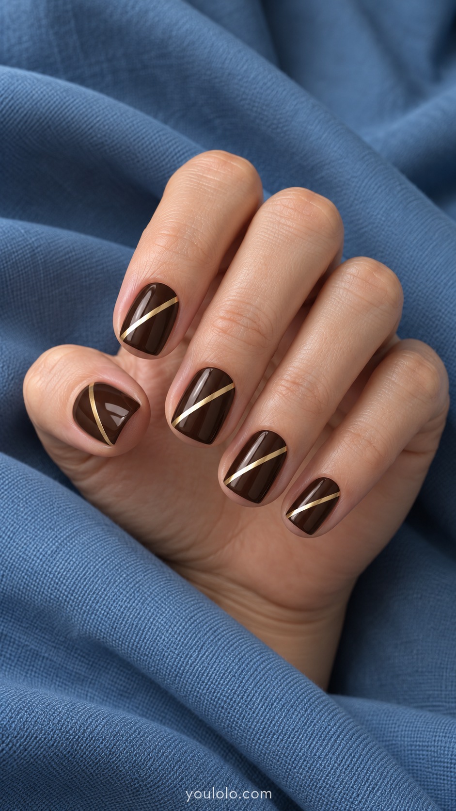 Short square nails dark chocolate base one thin flat gold diagonal ribbon per nail