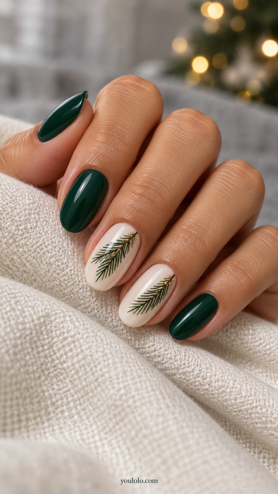 Medium oval milky ivory nails one fine emerald pine sprig on each middle and ring nail others solid emerald