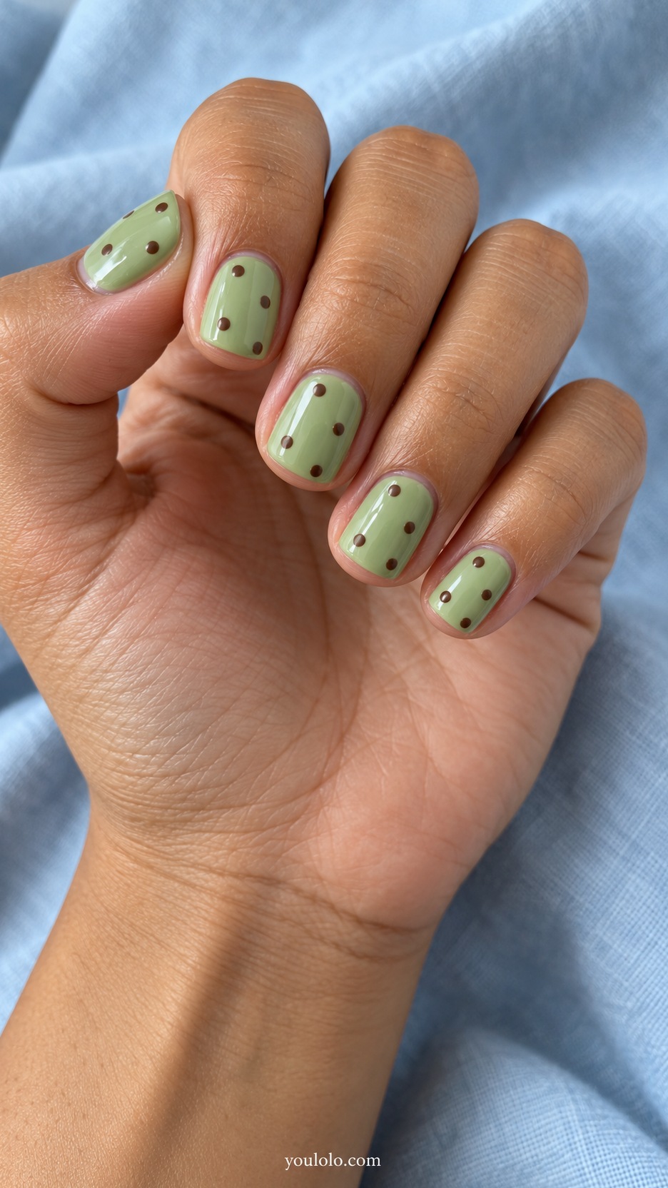 Short Square Nail Designs: Pistachio and Cocoa Dots manicure on a naturally posed hand