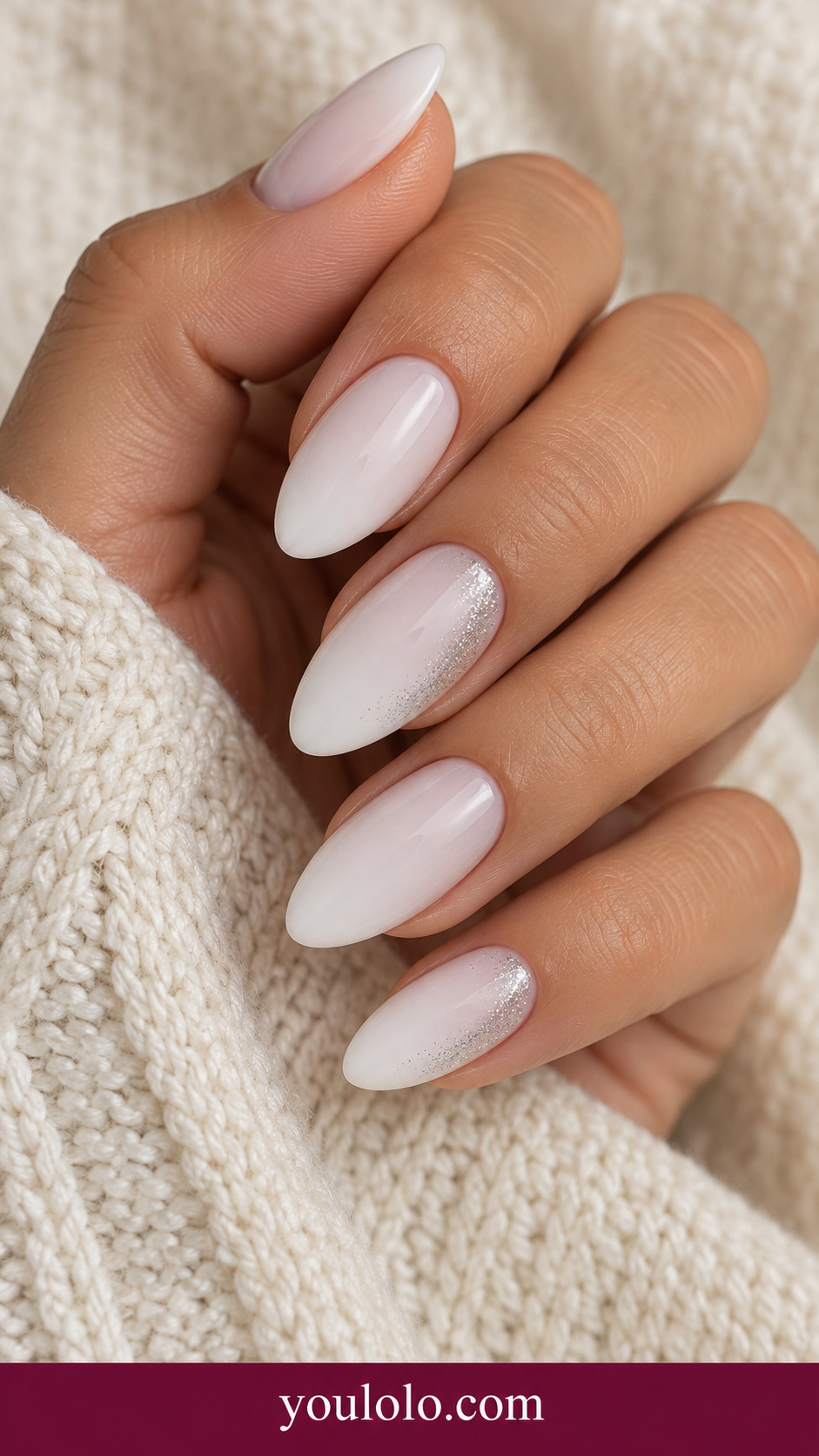 medium almond milky white nails extremely fine silver shimmer along one lateral edge on two accents, no magnetic cat eye on a naturally relaxed adult hand
